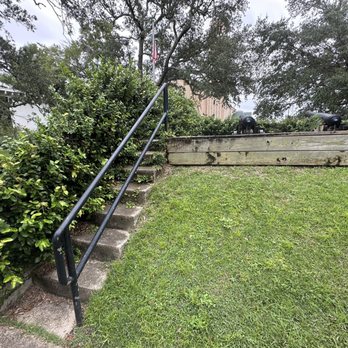 Fort George - Bushes overtaking the stairs the go up to the cannons. - Landmarks & Historical Buildings Near Me - Pensacola, Florida