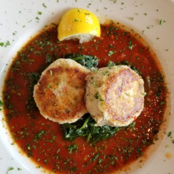 Side Door Cafe - crab cakes with sauteed greens and pomodoro sauce - New American Near Me - Gleneden Beach, Oregon