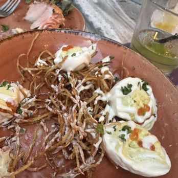 La Chev 208 - deviled eggs on potato strings. Whiskey and ginger beer. A bite of salmon on the other plate. - French Near Me - Summerville, South Carolina