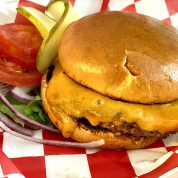Character's Sports Bar - "Flattop" Burger. Cooked to temperature. Served with lettuce, tomatoes, sliced red onion, and pickles. - Sports Bars Near Me - Denver, Colorado