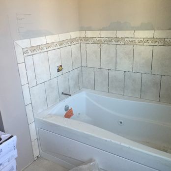 DH Renovation - a bathtub in a bathroom being remodeled - General Contractors Near Me DH Renovation - a bathtub in a bathroom being remodeled - General Contractors Near Me