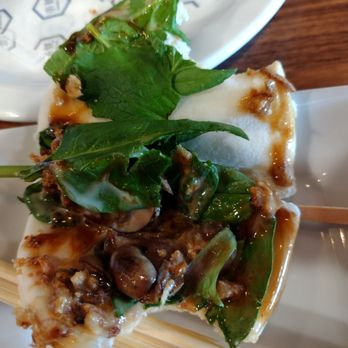 RAKKAN Ramen - Folsom - Vegan Bun, opened to reveal contents. One small bite was taken, so about 4 bites in total. - Ramen Near Me - Folsom, California