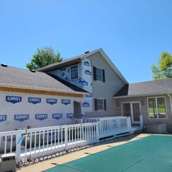 Colwell Construction - Working on installing vinyl siding