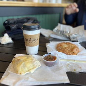 Rooted by the Bay - Front: Sausage burrito w salsa Middle: almond crème pastry - Cafes Near Me - Blaine, Washington Rooted by the Bay - Front: Sausage burrito w salsa Middle: almond crème pastry - Cafes Near Me - Blaine, Washington