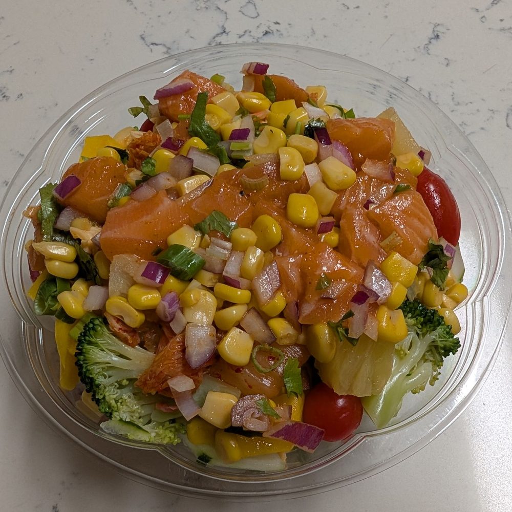 Spicy salmon, rice, onion, scallion, cilantro, seaweed salad, crab salad, kimchi, broccoli, cucumber, tomato, corn, mango, and pineapple Spicy salmon, rice, onion, scallion, cilantro, seaweed salad, crab salad, kimchi, broccoli, cucumber, tomato, corn, mango, and pineapple
