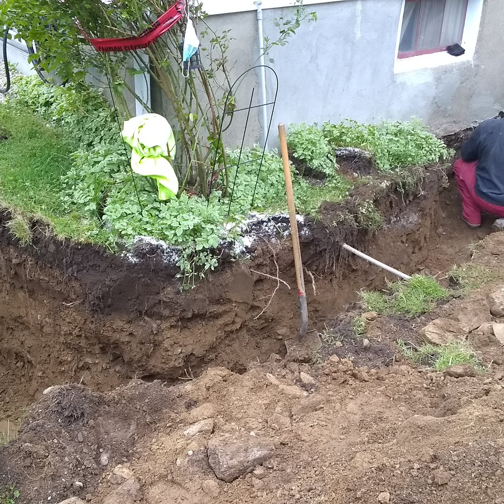 Candee Construction - a man digging a hole in the ground - General Contractors Near Me - Bridgeport, Connecticut Candee Construction - a man digging a hole in the ground - General Contractors Near Me - Bridgeport, Connecticut