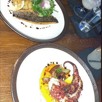 Fabrika - Branzino on top w/ a garlic & butter sauce. Grilled octopus on the bottom. Both were yummy!! - Seafood Near Me - Jackson Heights, New York Fabrika - Branzino on top w/ a garlic & butter sauce. Grilled octopus on the bottom. Both were yummy!! - Seafood Near Me - Jackson Heights, New York