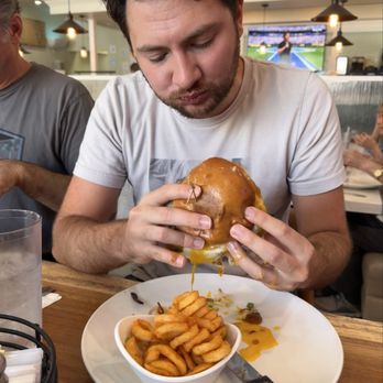 Broken Yolk Cafe - Breakfast burger with a runny egg, he enjoyed it! - Breakfast & Brunch Near Me - Carlsbad, California