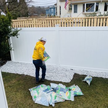 Watch City Construction - White fence vinyl and white rocks for the border - Masonry/Concrete Near Me - Weston , Massachusetts