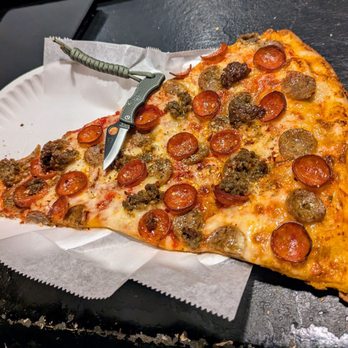 Pizza Bar Collins Ave - Meat Lover's slice - knife  and paper plate for scale. - Pizza Near Me - Miami Beach, Florida