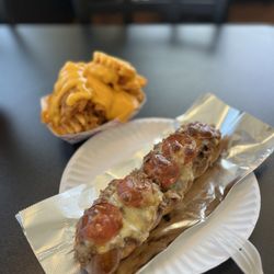 Twisted Steaks - Cheesy waffle fries pretzel cheesesteak with hot honey drizzle