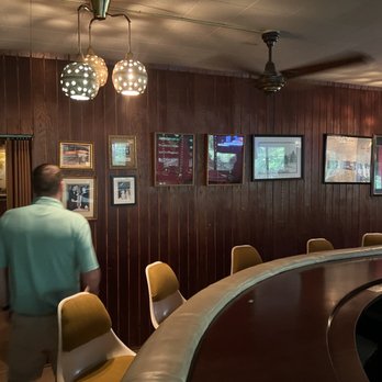 Dam Site Inn - a man and a woman standing at the bar - Seafood Near Me - Pellston, Michigan