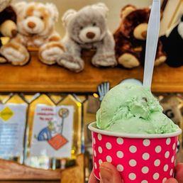 a hand holding a cup of ice cream a hand holding a cup of ice cream