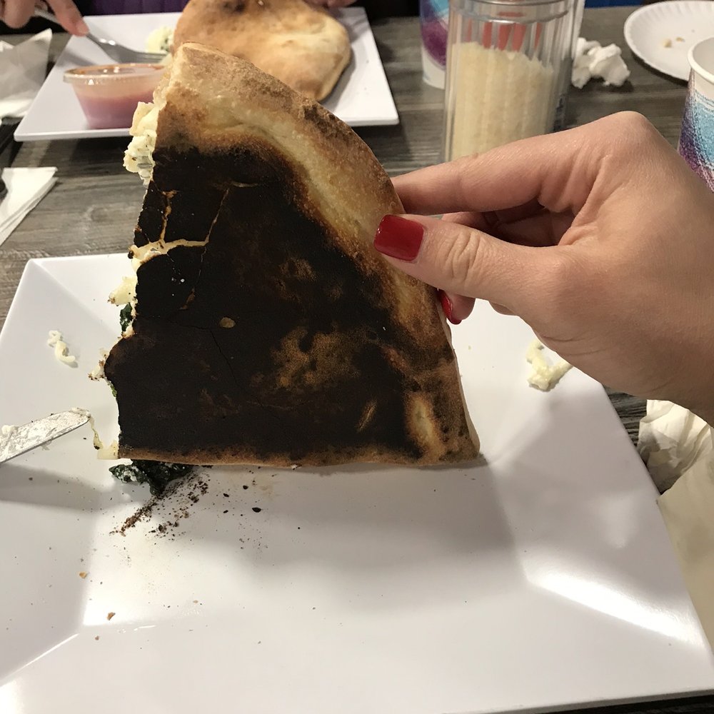 After 45 minutes, we got the wrong order. When they remade our order, spinach came out frozen and the calzone was burnt! Avoid!