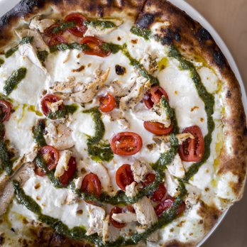 PORT - Chicken Caprese Pizza (basil pesto, cherry tomatoes, Parmesan, white sauce), done in their wood fired pizza oven - Seafood Near Me - Pickering, Ontario PORT - Chicken Caprese Pizza (basil pesto, cherry tomatoes, Parmesan, white sauce), done in their wood fired pizza oven - Seafood Near Me - Pickering, Ontario