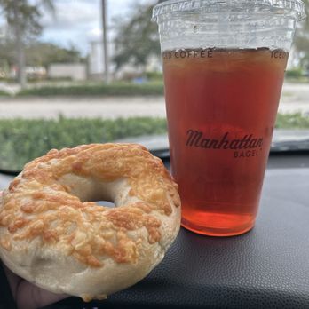 Manhattan Bagel - Asiago bagel and cold ice tea - Bagels Near Me - Coral Springs, Florida Manhattan Bagel - Asiago bagel and cold ice tea - Bagels Near Me - Coral Springs, Florida