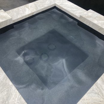 Chaidez Quality Pools - Black mini pebble spa filled with water. - Pool & Hot Tub Service Near Me Chaidez Quality Pools - Black mini pebble spa filled with water. - Pool & Hot Tub Service Near Me