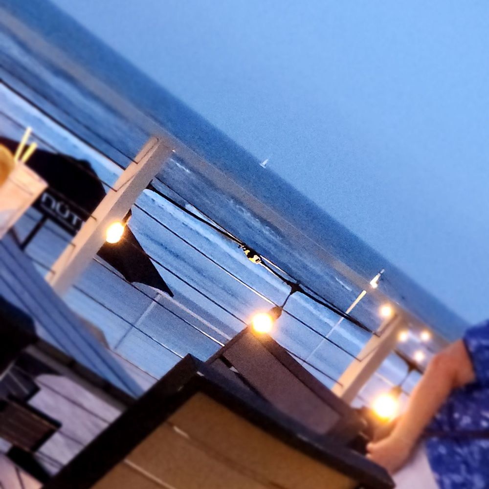 Chase's on the Beach - Evening visit desk with a sailboat in the background - American Near Me - New Smyrna Beach, Florida