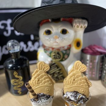 Hanamaru Cafe - a cat wearing a witch hat and holding a cookie - Japanese Near Me - San Antonio, Texas Hanamaru Cafe - a cat wearing a witch hat and holding a cookie - Japanese Near Me - San Antonio, Texas