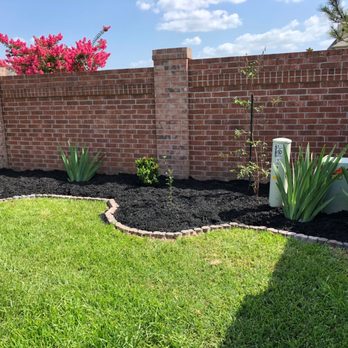 Alvarado Landscaping - a brick wall with a garden border - Tree Services Near Me Alvarado Landscaping - a brick wall with a garden border - Tree Services Near Me
