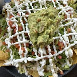 Loaded nachos with lots of guacamole
