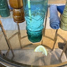 Fake bamboo paper straw, sad tiki glass from Temu, soggy previously frozen lemons that made no sense as a garnish for my drink...