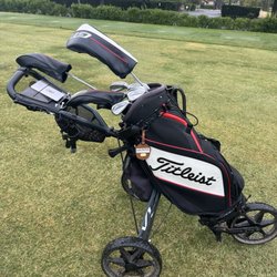 Clubs are loaded on this push cart and when you're done warming up- take it to the area with the carts and they swap it