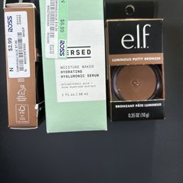 In this photo, you will find two elf bronzers, one showing the price and one showing the product and Versed moisturizing serum.