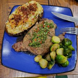 Freshly Made By Layha - Twice baked fully loaded potato, chimichuri Ribeye, and seasoned Brussels