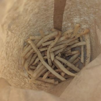 Cluck Cluck Moo Moo - a close up of a paper bag filled with food - Burgers Near Me - Buffalo, New York