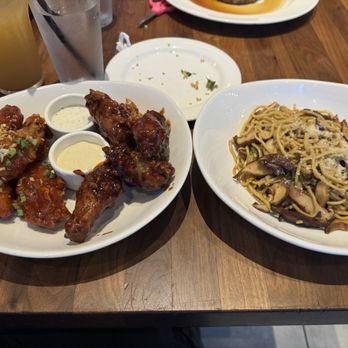 Yard House - 10 Crispy Traditional Wings on left Shiitake Garlic Noodles on right - New American Near Me - New York, New York Yard House - 10 Crispy Traditional Wings on left Shiitake Garlic Noodles on right - New American Near Me - New York, New York