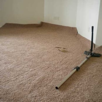 True Quality Carpet Repairs - a room with a vacuum on the floor - Carpet Installation Near Me - Aurora, Colorado True Quality Carpet Repairs - a room with a vacuum on the floor - Carpet Installation Near Me - Aurora, Colorado