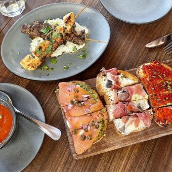 Postino Broadway - Roasted red pepper soup, SKEWERS, BRUSCHETTA (CHOOSE 4): smoked salmon, prosciutto, spicy jam & goat cheese, burrata & bacon - Wine Bars Near Me - Denver, Colorado
