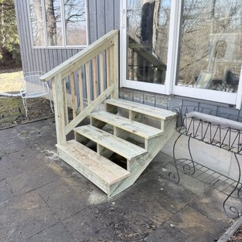 SLB & Sons Construction - Green treated steps with railing for back patio. - General Contractors Near Me
