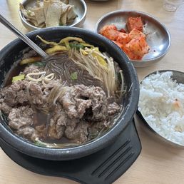 Bulgogi soup with glass noodle, and side dishes like fish cake, pickled radishes, and kimchi. Bulgogi soup with glass noodle, and side dishes like fish cake, pickled radishes, and kimchi.