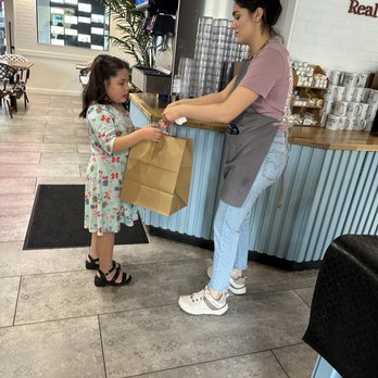 RealGood Brunch - Our server helping our granddaughter with her to go items - Breakfast & Brunch Near Me - Tucson, Arizona RealGood Brunch - Our server helping our granddaughter with her to go items - Breakfast & Brunch Near Me - Tucson, Arizona