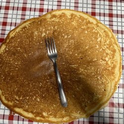 Sissy's - You can't see the plate under this ginormous pancake.  It only is it large but it's thick and cooked throughout.
