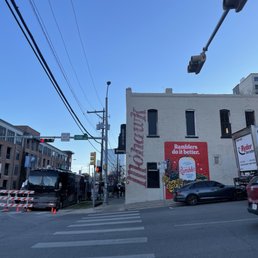 a street corner with cars parked on the side of the road