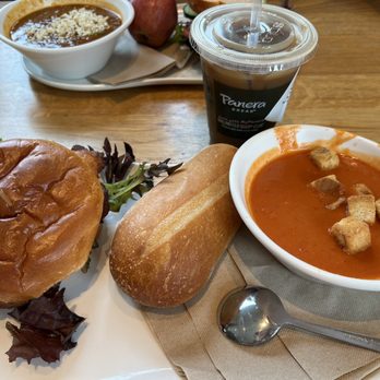 Panera Bread - Tomato Soup, Signature Take Chicken Sandwich, Madagascar Vanilla Almond Iced Coffee (Tina Masala Soup in background) - Sandwiches Near Me - Quincy, Illinois