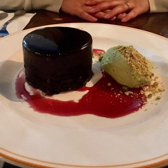 Capocaccia Trattoria - MUST TRY DESSERT!!! Rich chocolate mousse cake with cherries, paired with pistachio whipped cream. Come here just for this! - Pizza Near Me - Toronto, Ontario