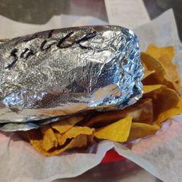 a closeup of a burrito with chips