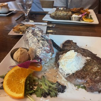 Kane’s Cattle - 12 oz ribeye with garlic butter & sweet potato - Steakhouses Near Me - Crystal River, Florida Kane’s Cattle - 12 oz ribeye with garlic butter & sweet potato - Steakhouses Near Me - Crystal River, Florida