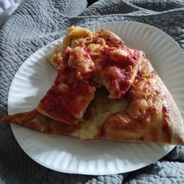 a slice of pizza on a paper plate a slice of pizza on a paper plate