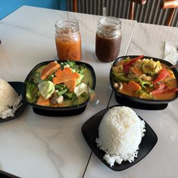 Vegetarian green curry with Thai iced tea (left), and vegetarian pumpkin curry with Thai iced coffee (right).