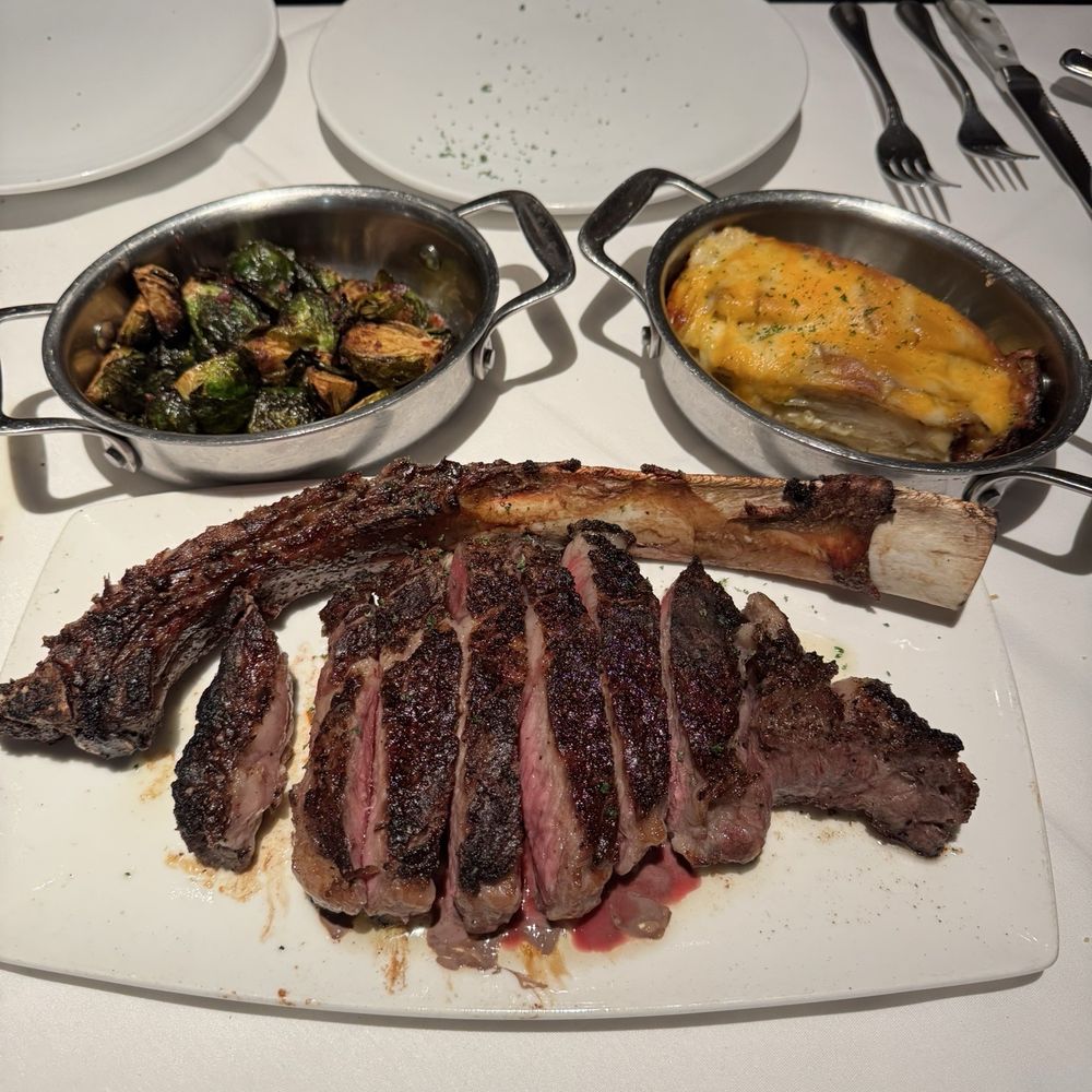 Fleming’s Prime Steakhouse & Wine Bar - 35oz Prime Tomahawk To Share, Crispy Brussels Sprouts & Bacon and Fleming's Potatoes - Steakhouses Near Me - Mclean, Virginia Fleming’s Prime Steakhouse & Wine Bar - 35oz Prime Tomahawk To Share, Crispy Brussels Sprouts & Bacon and Fleming's Potatoes - Steakhouses Near Me - Mclean, Virginia