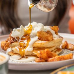 OEB Breakfast Co. - Yaletown - Buttermilk pancake stack, roasted cinnamon apples, chantilly cream, Quebec maple syrup.