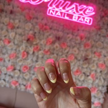 D'Luxe Nail Bar - Simple, pale yellow color block with cross charm - Nail Salons Near Me - Temecula, California
