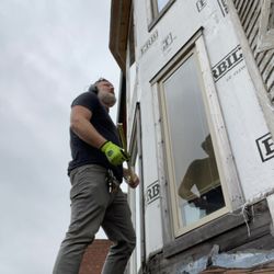 CW Goines Arts - Carl installing flashing on a siding project in Detroit.