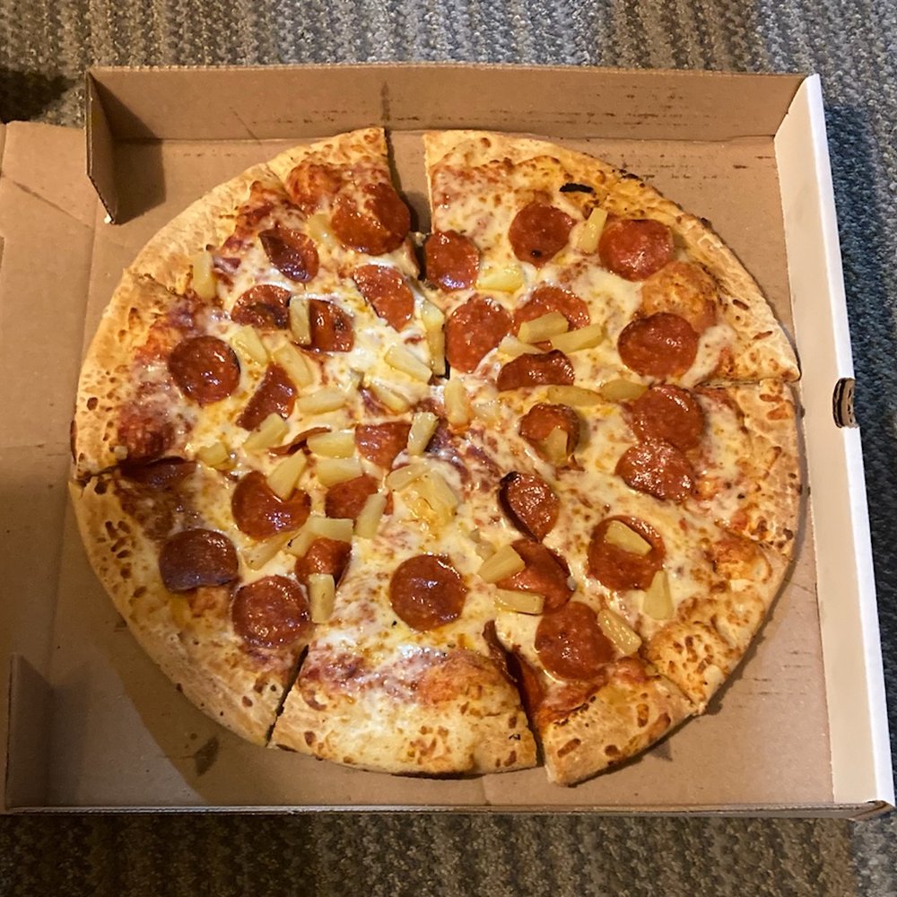 A large pepperoni and pineapple pizza. A large pepperoni and pineapple pizza.