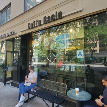 Caffe Bacio - two people sitting on a bench outside a coffee shop - Coffee & Tea Near Me - New York, New York